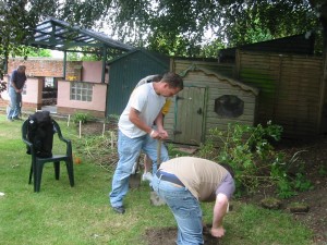 The team getting stuck in to clearing the grass